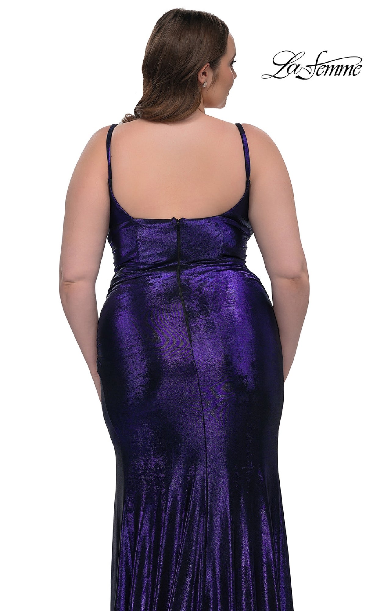 A woman models the Plus-Size Long Metallic Prom Dress La Femme 33020 in shiny dark purple, showcasing its thin straps, sleeveless cut, and back zipper against a white background.